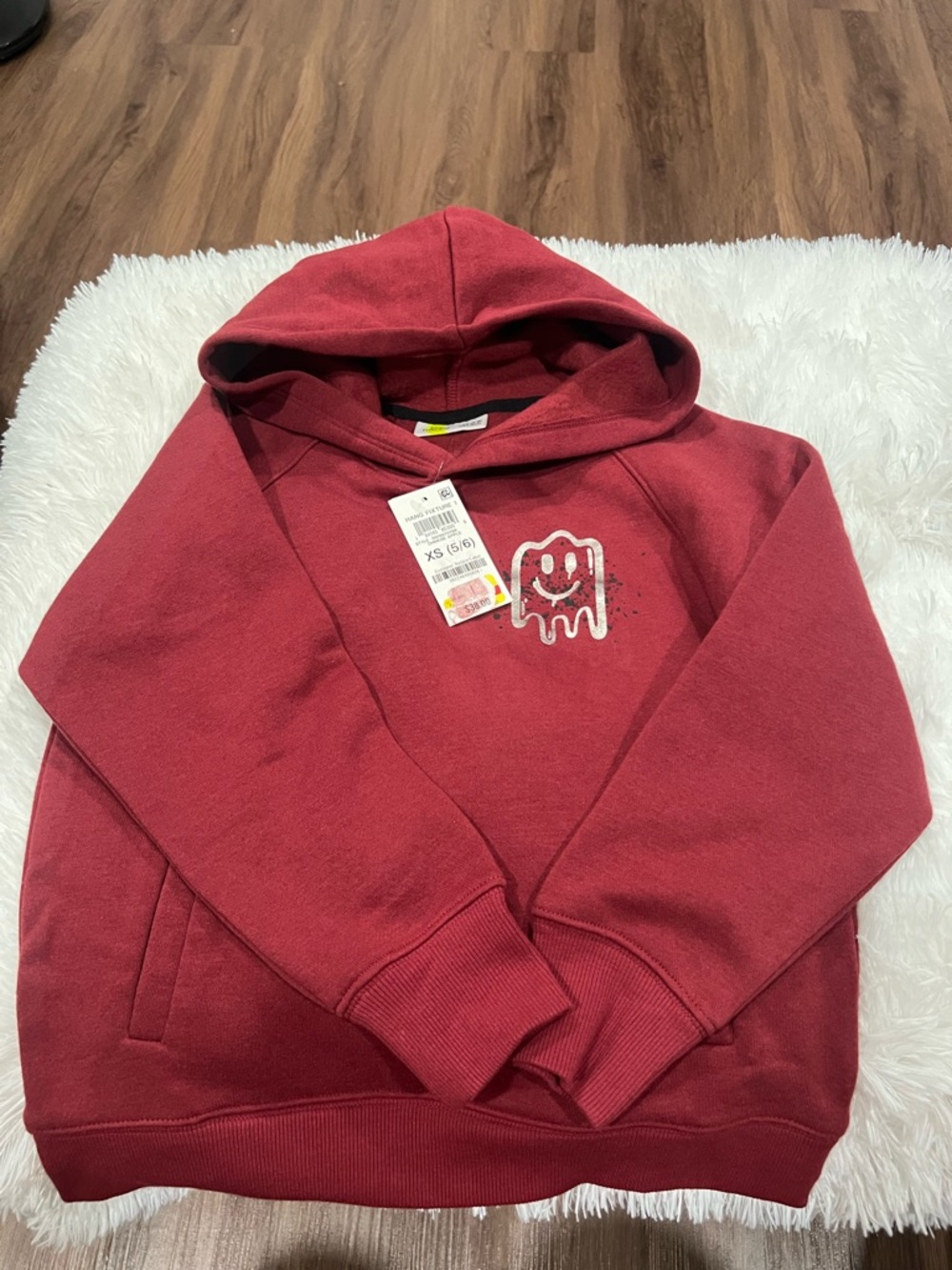 Red Hooded Sweatshirt with Smiley Melt Graphic